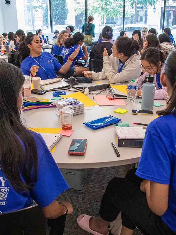 HS students sit around round table